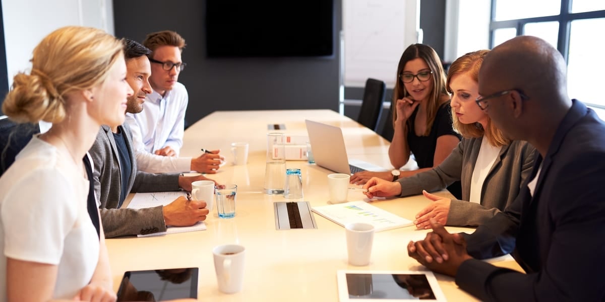 Colleagues talking around a table